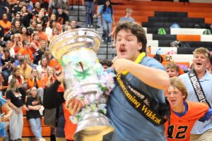 Senior Myles Batesky rushes out into the crowd after being crowned Homecoming Wildcat by the student body vote, carrying his senior class’ coveted spirit cup, at the end of the assembly.