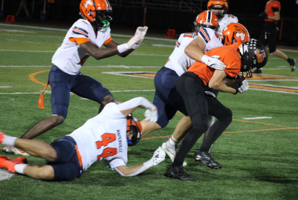  LHS Running back bulldozes across the field through Naperville junior Gianni Fonash, putting on an amazing first performance as a varsity running back. The LHS team went on to have an amazing game getting this possession to the 4 yard line, allowing senior quarterback Trevor Wallace to take it in for a touchdown to tie the game at halftime. 
