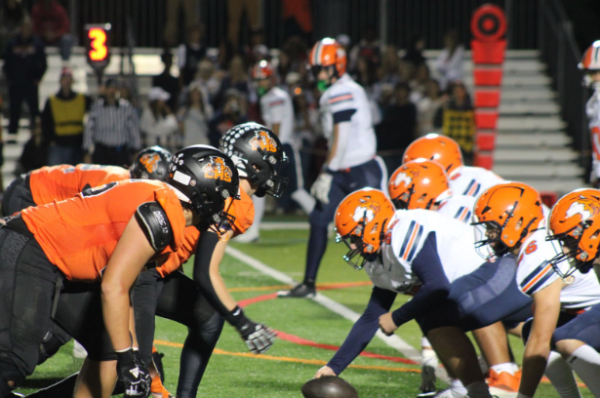 Both the offensive line of Naperville North and the defensive line of Libertyville face off in the beginning of the second quarter in a down to the wire game. “Just two teams that are really good, two really good programs going at each other,” Head Coach Tim Budge said.
