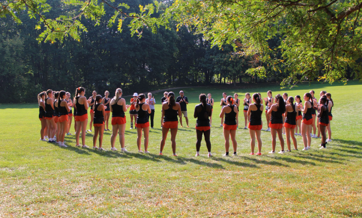 Wildcats doing their pre race circle that consists of chants and cheers to hype up the team.
 “I think cross country is such an interesting sport, in the way we're all kind of struggling together at the same time. So having comfort knowing that everyone's kind of going through the same thing. It's kind of incredible.” Senior Emme Fogle said
