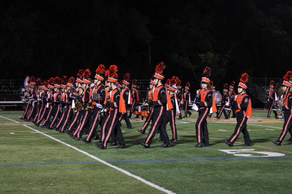 The Marching Wildcats perform their Deep Blue Sea halftime show led by drum majors senior Joey Kim and junior Lexi Likosar. Their halftime presentation follows a pirate theme this year, including songs from Jaws, Moana and Pirates of the Caribbean. The band also performs for the dance team's show.