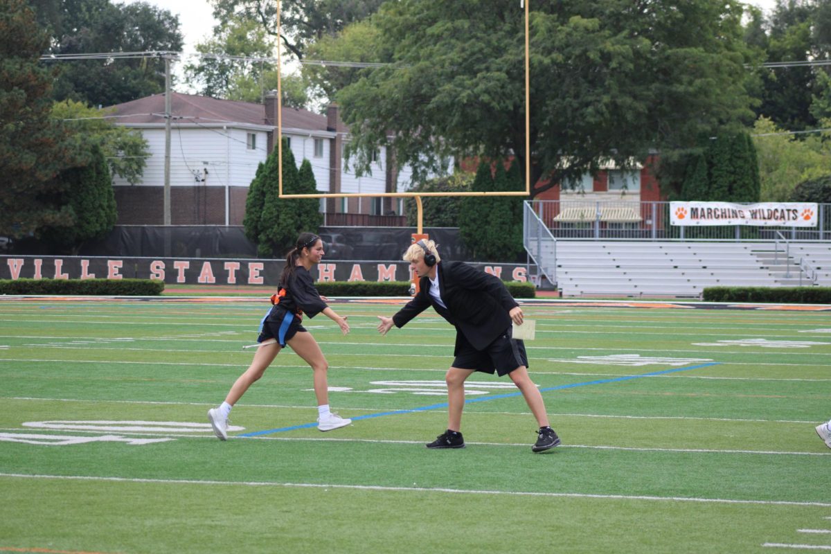 Aanya Singh and Matthew Moore celebrate after a successful defensive play by the team. Moore was a coach alongside Jacob Allen, Chathen Nickerson and Garrett Phillips.