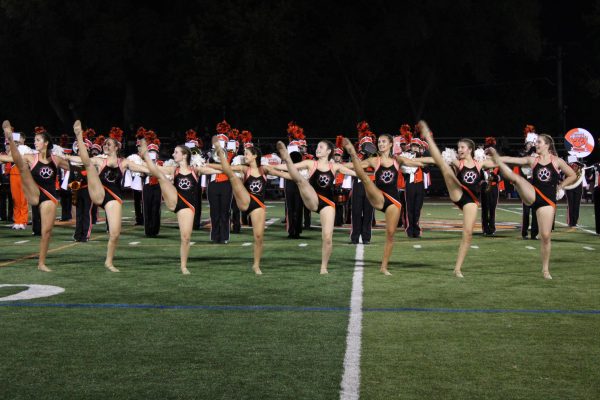 The varsity dance team showcases their abilities with a kick line during their halftime performance. They do a routine to Good Vibrations which is played by the Marching Wildcats. Freshman Liv Hilliard said, “Getting to dance with all the older girls,” is her favorite part because, “they make me feel so welcome, and it's just so much fun.”