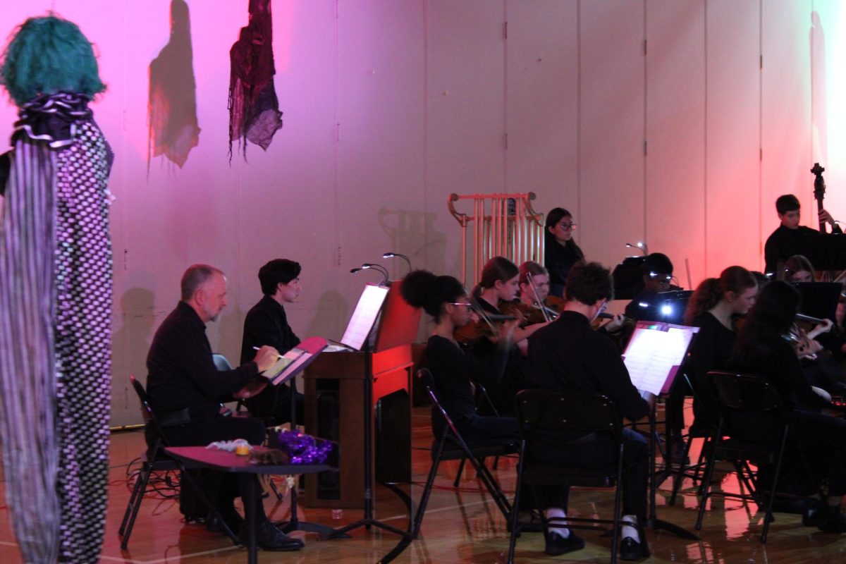 Band Director Adam Gohr joins the Orchestra for a piece including the Theremin, a unique digital instrument that adds a spooky quality to the piece. 