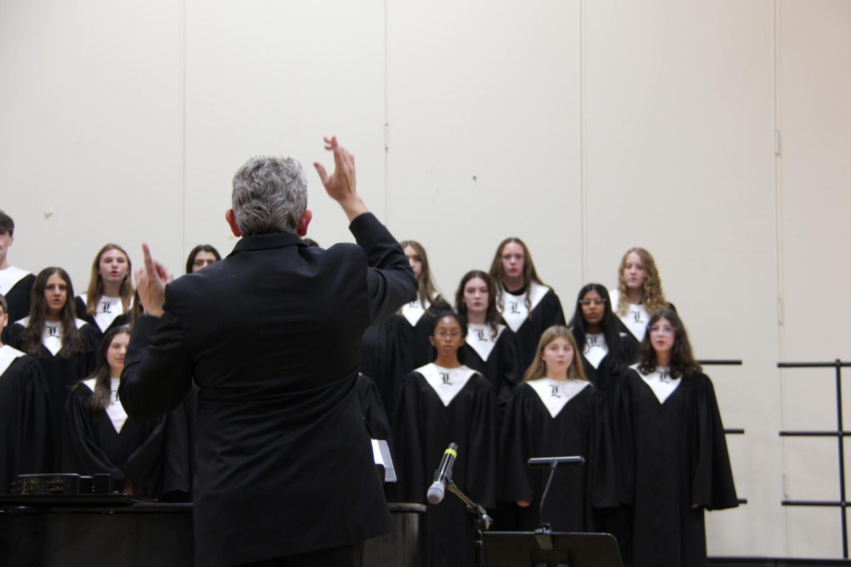 Dr. Brown conducts the Chorale during their song “The Cuckoo” Arr. Robert Hugh. This was the Chorale’s first concert as high school students. Freshman Gigi Loffredo said “I joined because I thought it would be really great to get better at singing number one, and I think [Dr. Brown] makes class so much fun every single day, and class with my friends every day has been such a joy.”

