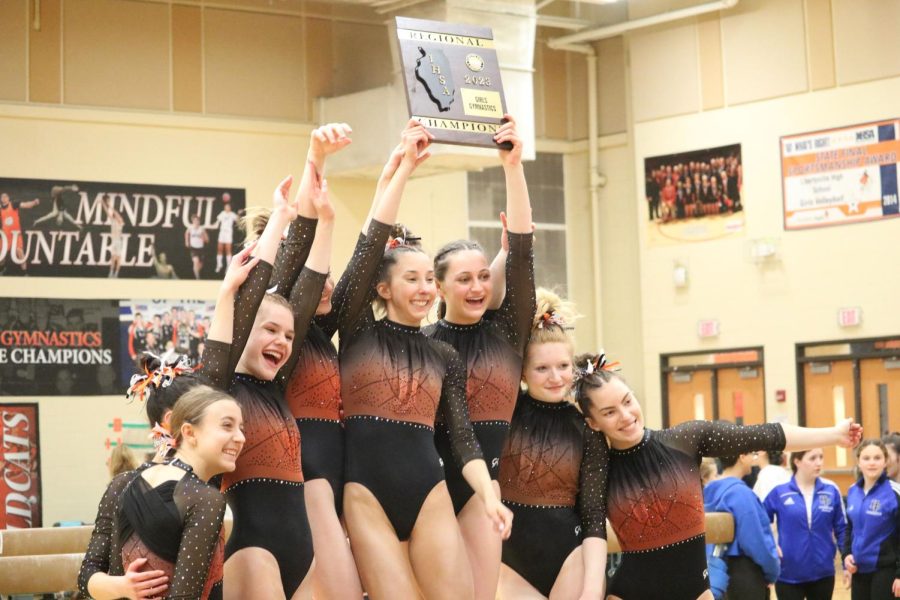 The 2022-2023 Gymnastics team wins  their regional meet for the first time in 14 years. Holding up the plaque is LHS alum ‘23 senior Anna Becker and former LHS alum ‘24 Ally Humbert. Becker went on to win the state championship in Palatine for her last season for her LHS gymnastics career.