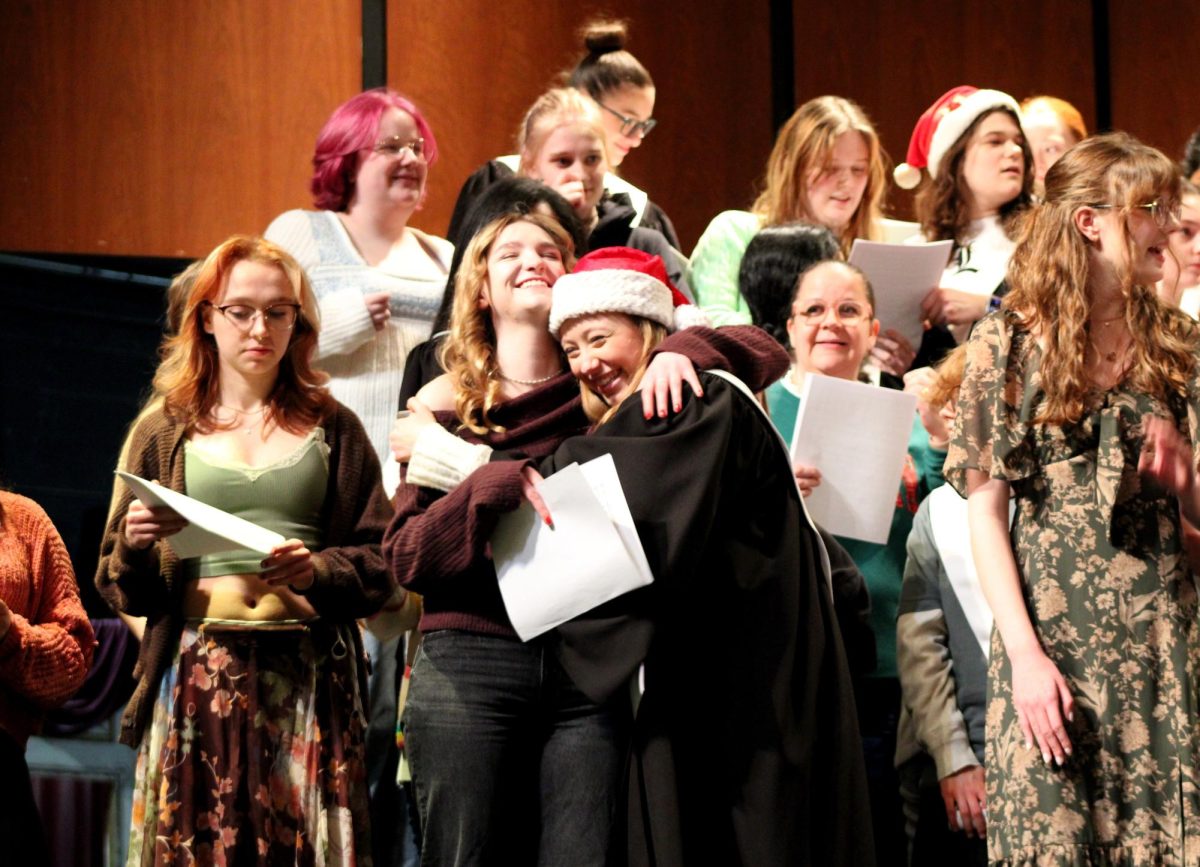 Junior Juliana Rodriguez reunites with '25 alumna Delaney Rybicki during "Hallelujah" by G.F. Handel. For this performance, the choir invited those in the audience to join them on stage. This tradition brings a variety of alumni and family members of all ages to participate.