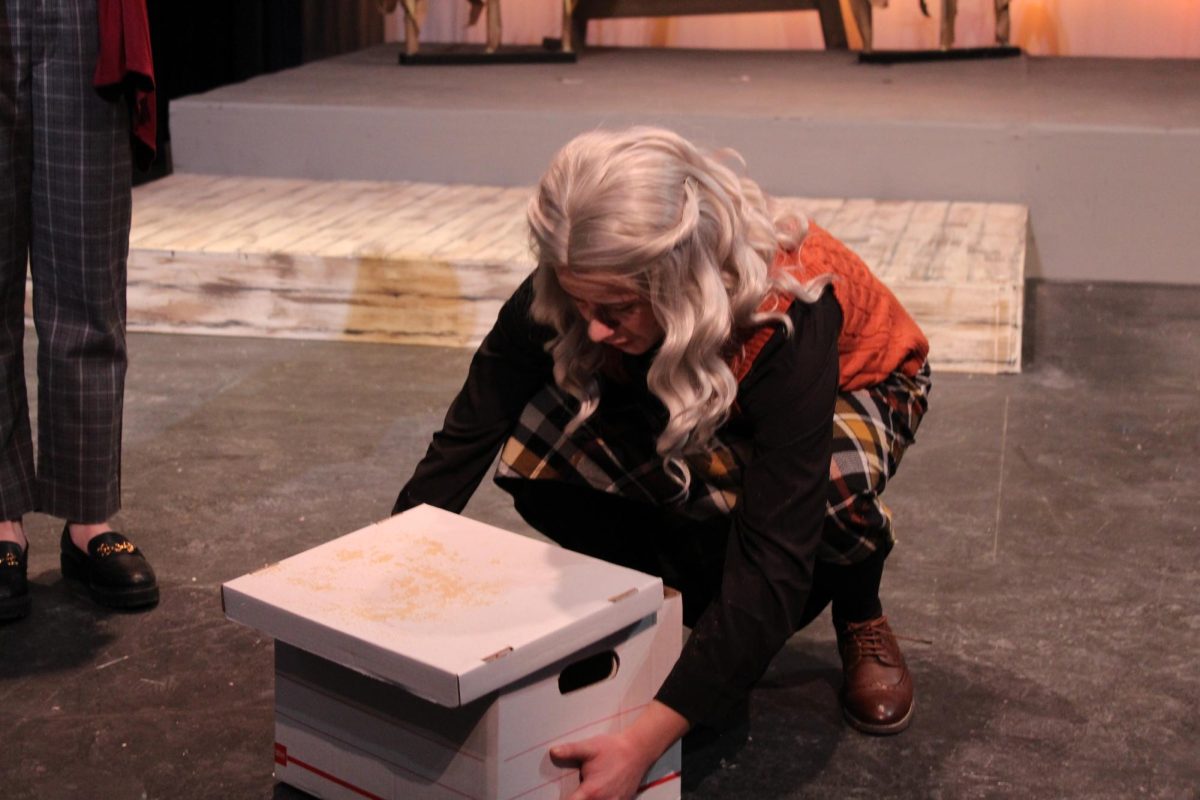 The older Mom, sophomore Emma Dillon, brings out a box from their basement. From inside the box, she pulls out her late husband's ashes. Her son Don, sophomore Charlie Wells, decides to drive to his grandparents' house to spread the ashes.
