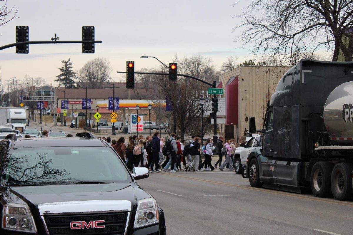 The group of students crosses Lake Street to further show their political beliefs. From freshmen to seniors, the students protesting came not only from a variety of ages but also race, gender and other identities.