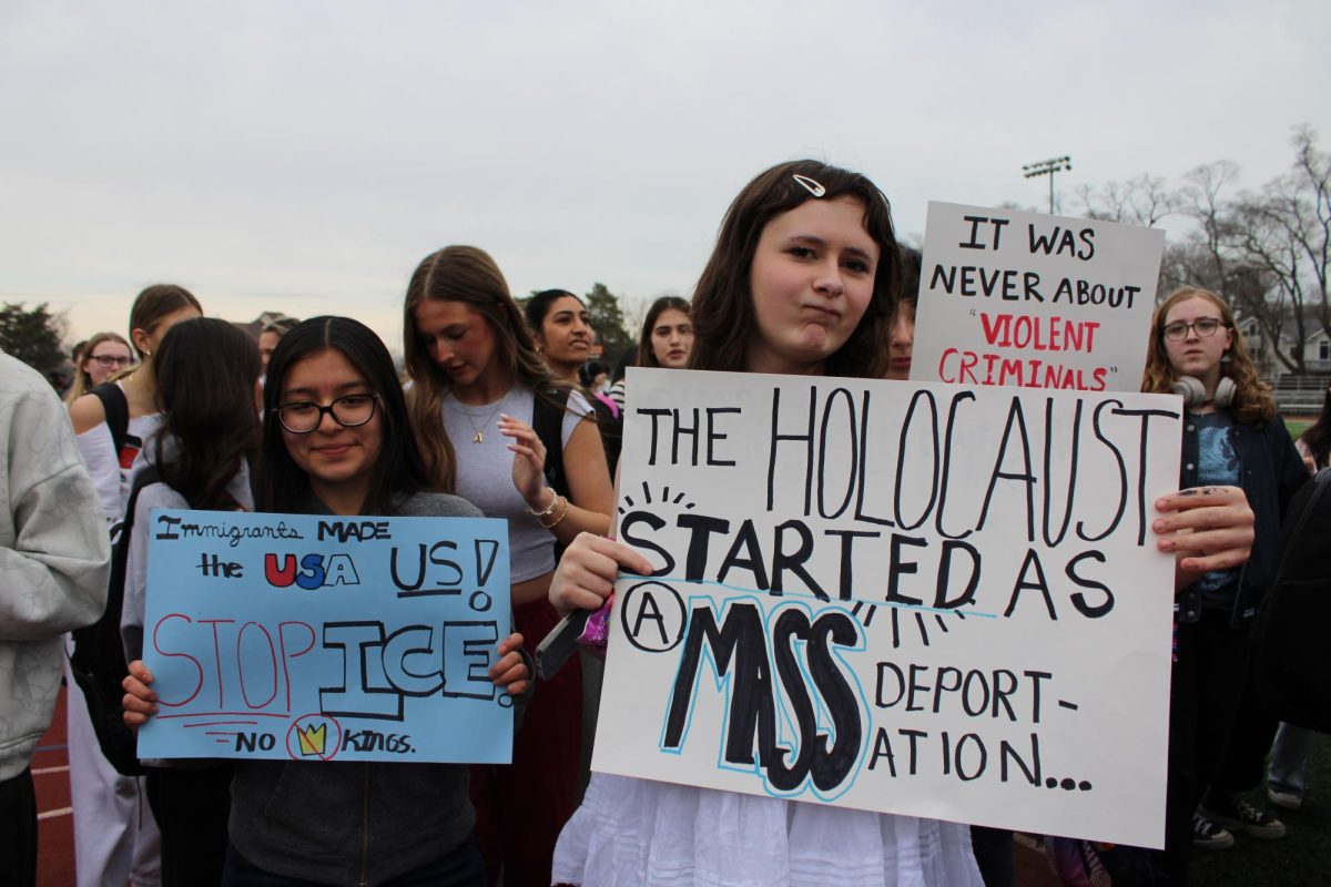 Junior Noli Chatman and senior Nina Hernandez hold up their handmade signs, hoping to have their voice heard. “I think it's terrible to rip apart innocent families,” Chatman said.