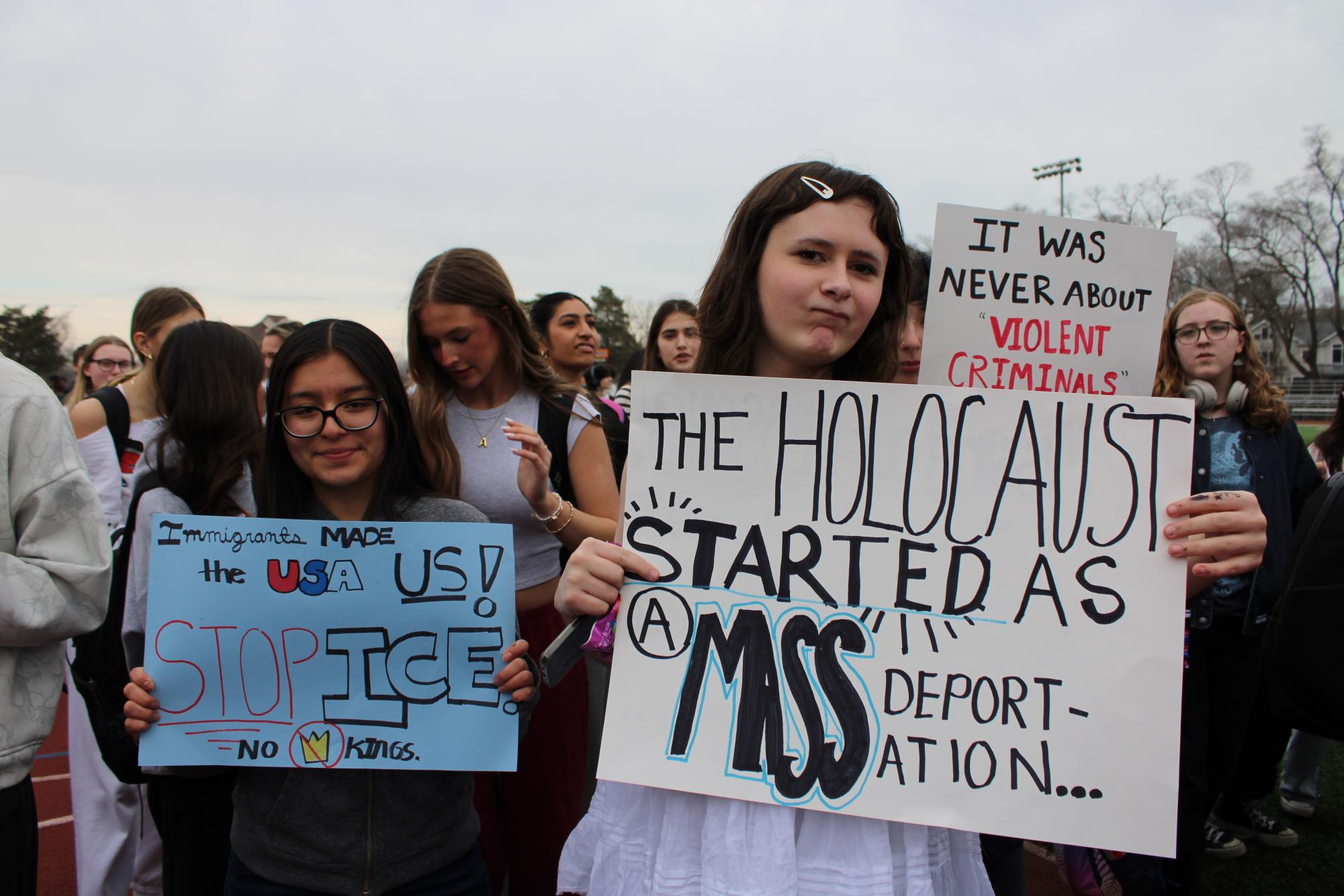 Junior Noli Chatman and senior Nina Hernandez hold up their handmade signs, hoping to have their voice heard. “I think it's terrible to rip apart innocent families,” Chatman said.