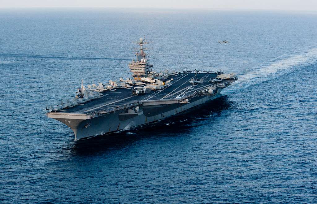 The USS Abraham Lincoln, pictured here in 2012, is one of the warships that have been deployed to the Middle East amid nuclear negotiations with Iran. According to the BBC, this vessel, along with the USS Gerald R Ford, another aircraft carrier deployed to the region, carry over 5,600 crew members and dozens of aircraft. (Photo Courtesy: NARA & DVIDS Public Domain Archive)
