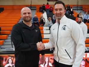 Coach Zyrkowski meets up with Athletic Director John Woods moments before the last regular season game of the year for Libertyville boys basketball.