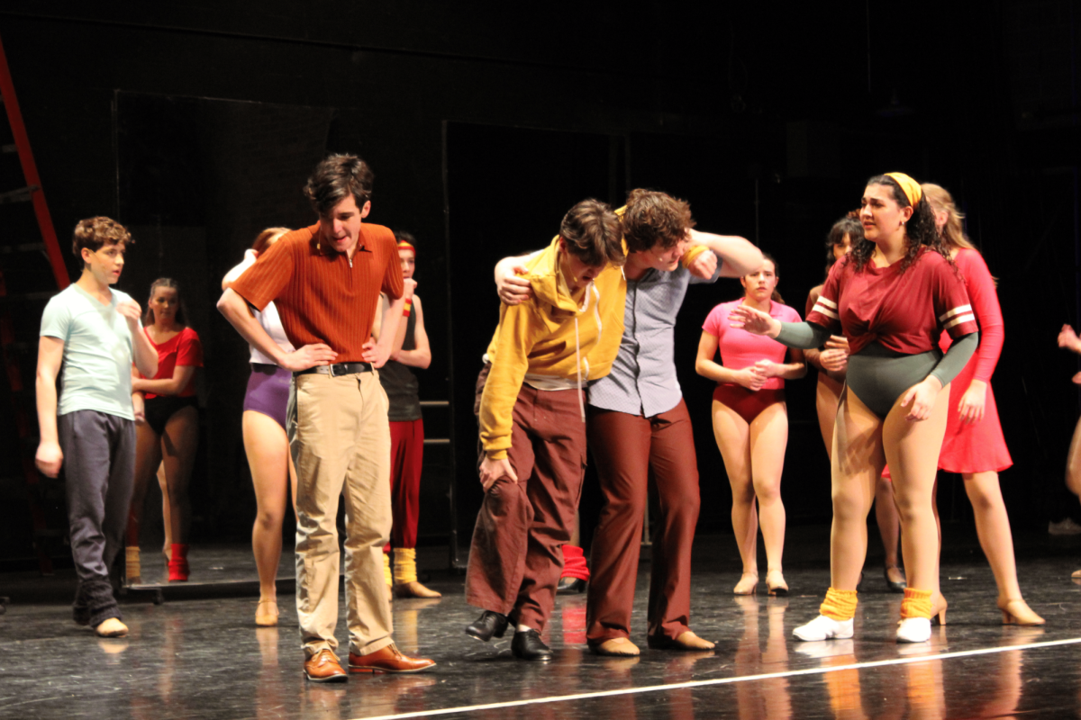 Paul, played by junior Kade Burroughs, suffers an unfortunate injury during the final stages of the audition and loses his chance at being part of the line. Mike, played by sophomore Owen Brown, helps him get to the hospital.
