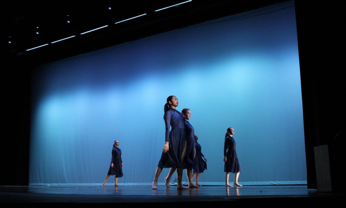 Dancers perform Not True, a piece choreographed by Quinn Mergen and Gabby Huber, bringing emotion to the stage through synchronized movement and expressive choreography.